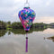 Balloon shaped lantern with flamingos in the wild outdoors.