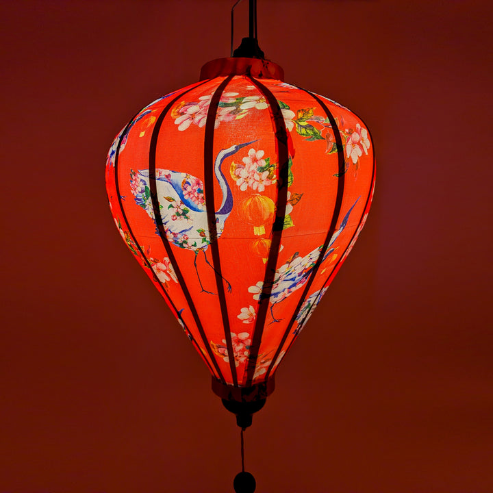 Glowing Balloon shaped Vietnamese silk lantern created a warm red hue.