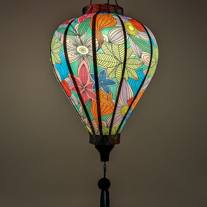 Glowing balloon shaped lantern with a vibrant and modern floral design on a blue background. 