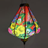 Glowing lantern with a print of flora, such as sunflowers and bluebells.