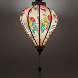 Up close of a glowing lantern with a light placed inside creating a soft warm glow.