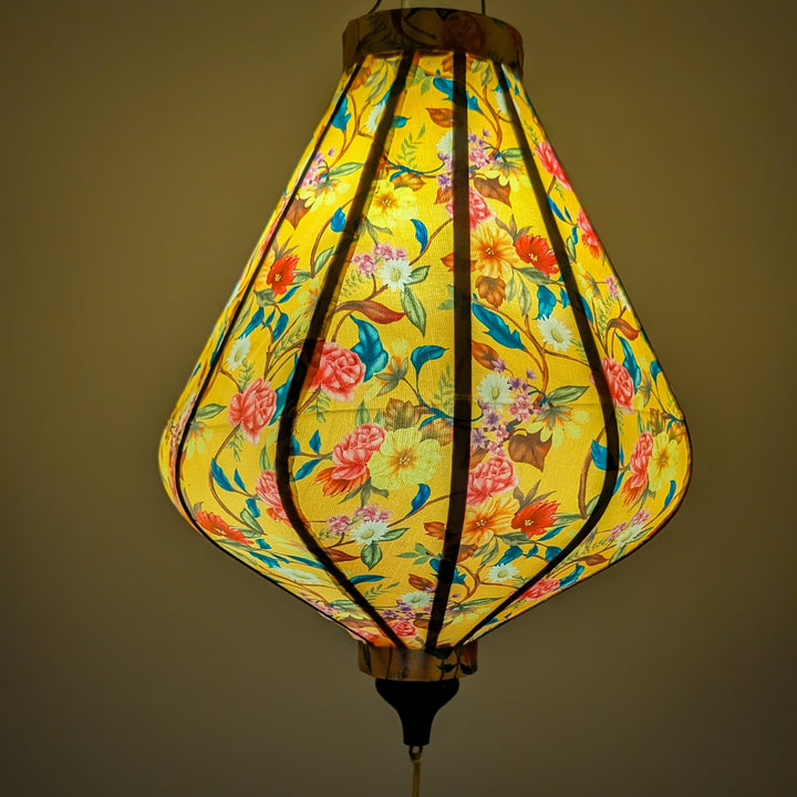 Teardrop shape lantern with floral pattern creating a gorgeous yellow glow 