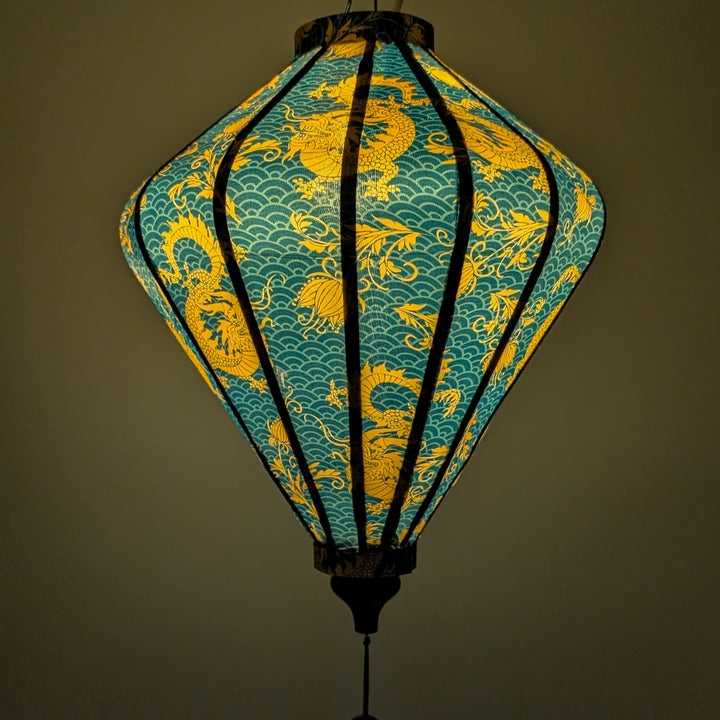 Glowing lantern with yellow dragon design on a teal background