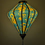 Glowing lantern with yellow dragon design on a teal background
