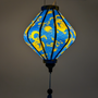 Glowing blue lantern with golden yellow dragon design