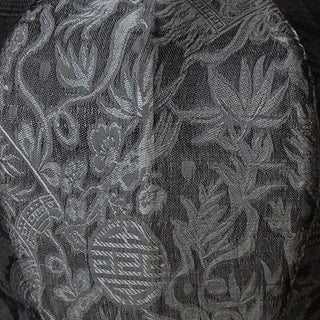 close up of grey and silver jacquard silk fabric