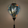 A balloon shaped lantern with light bulb inside creating a beautiful soft glow.