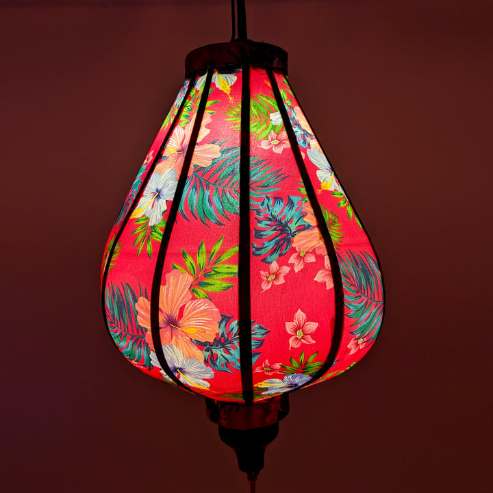 Vietnamese silk lantern with pink glow.