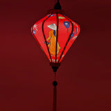 Handcrafted red Hoi An silk lantern with pink rose floral design, traditional Vietnamese home decor and cozy lighting.

