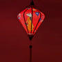 Handcrafted red Hoi An silk lantern with pink rose floral design, traditional Vietnamese home decor and cozy lighting.

