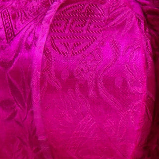 close up of hot pink jacquard silk fabric