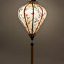 Glowing balloon shape Vietnamese silk lantern with hummingbirds and flowers on cream silk.