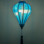 Glowing balloon shaped blue jacquard silk lantern with a tassel.