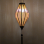 Glowing Vietnamese lantern with a textured gold and grey jacquard silk fabric.