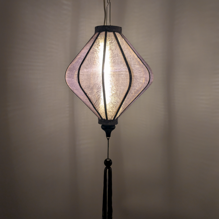 Hanging grey jacquard silk lantern with light bulb inside creating a grey glow 