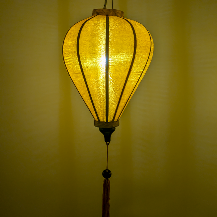 Glowing balloon shaped mustard Jacquard silk lantern.