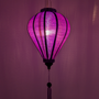 Glowing purple Jacquard silk lantern with intricate patterns against a purple background