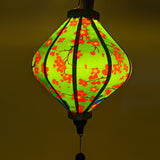 Lozenge shape lantern with red flowers and blue kingfisher birds with glowing green hue.