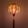 Glowing round lantern with fish design on a red background