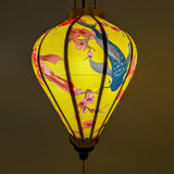 Glowing Balloon shape lantern with koi fish and cherry blossom creating a yellow hue