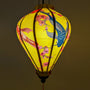 Glowing Balloon shape lantern with koi fish and cherry blossom creating a yellow hue