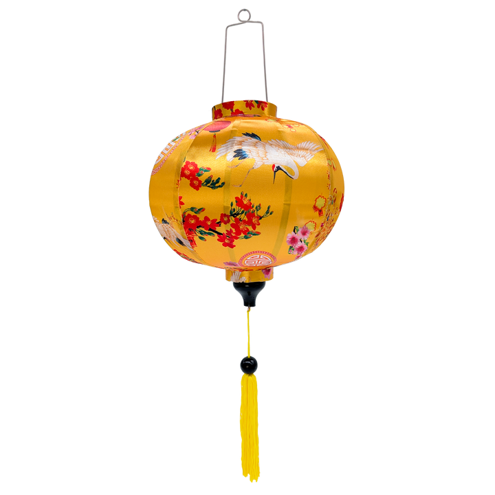 Round shape Vietnamese silk lantern handmade in Hoi An adorned with elegant cranes, encircled by lanterns, and pink and red blossoms, all set against a backdrop of brilliant yellow. 