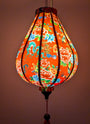 Glowing lantern with colourful floral and dragon design creating a red glow.