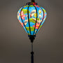 A glowing balloon shape Vietnamese lantern featuring a vibrant blue background adorned with grey-crowned cranes standing among large green lotus leaves, handmade in Hoi An.