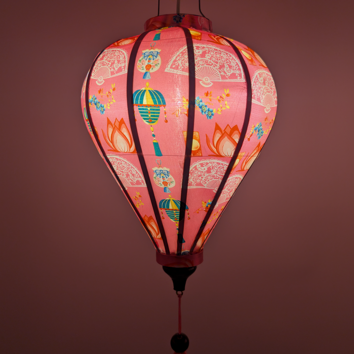 Glowing pink lantern with colourful designs.