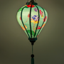 Glowing balloon shape lantern with delicate petals, lush green leaves and detailed lotus seed pods in shades of pink, blue, and yellow create a gorgeous contrast.