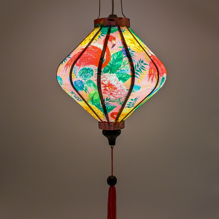 Glowing lozenge shape lantern with tropical flamingo paradise print, with intricate floral details in shades of gold, purple featuring bold pink flamingos surrounded by lush tropical flowers.