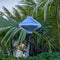 Vietnamese silk lantern with plain silver grey colour in a UFO shape near palm leaves and river with flowers.