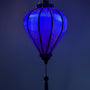 Balloon shape dark blue polyester silk lantern glowing with a blue hue. Handmade in Vietnam.