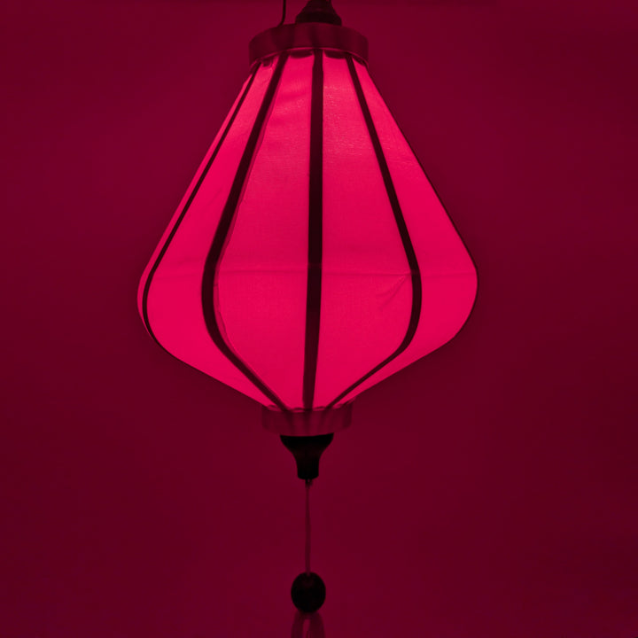 Hot pink Vietnamese lantern lit from inside, creating a beautiful pink glow.