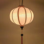 Glowing light pink plain polyester silk lantern made with fabric and bamboo from Hoi An, Vietnam.