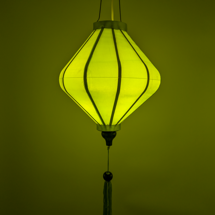 Plain silk Lime Green hanging lantern with lightbulb inside creating a green glow.