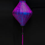 A lozenge shaped lantern with purple and blue jacquard silk fabric and purple tassel.