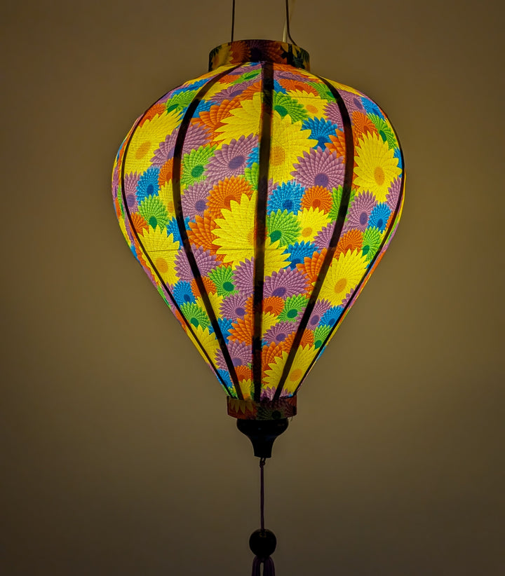 Balloon shaped lantern with fractal print glowing from a lightbulb inside.