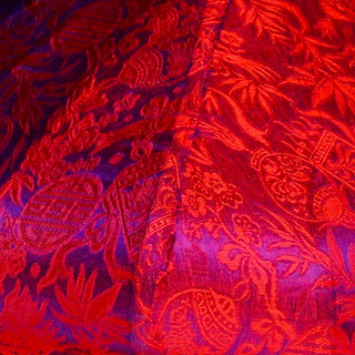 close up of purple and red jacquard silk fabric