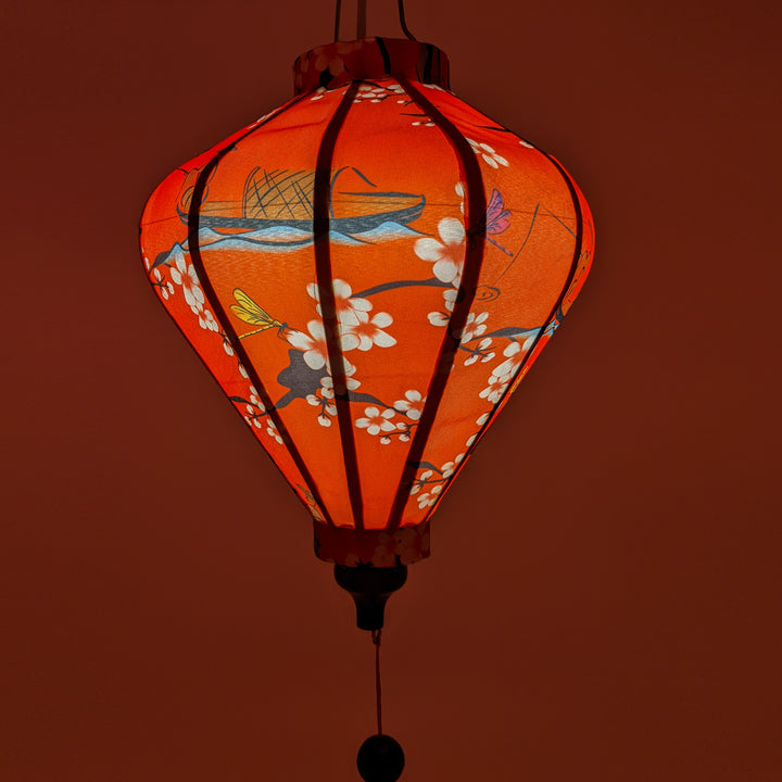 Close up of a Diamond shape lantern with a red glow.