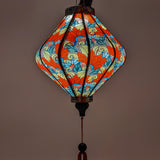 Vibrant silk lantern showcasing ornate feather and paisley prints, blending bohemian style with Vietnamese craftsmanship.
