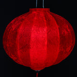 close up of a round red jacquard silk Vietnamese lantern