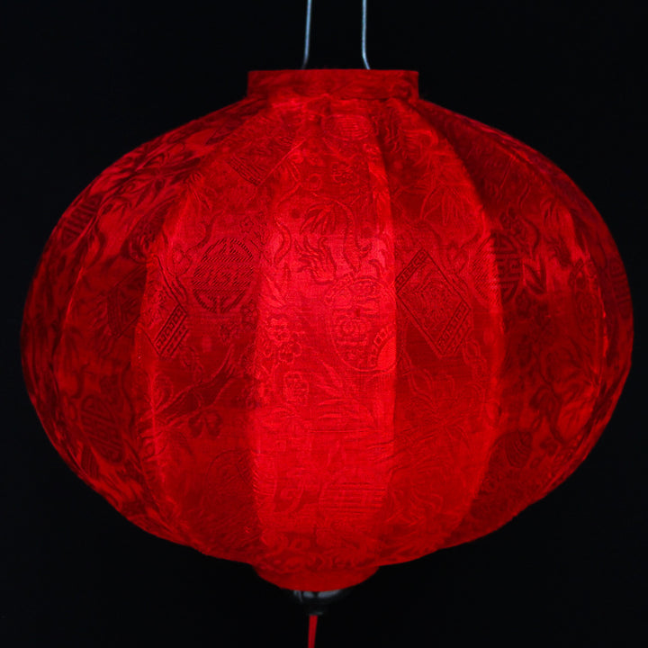 close up of a round red jacquard silk Vietnamese lantern