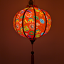 Colourful Tet theme lantern with patterns on a red background