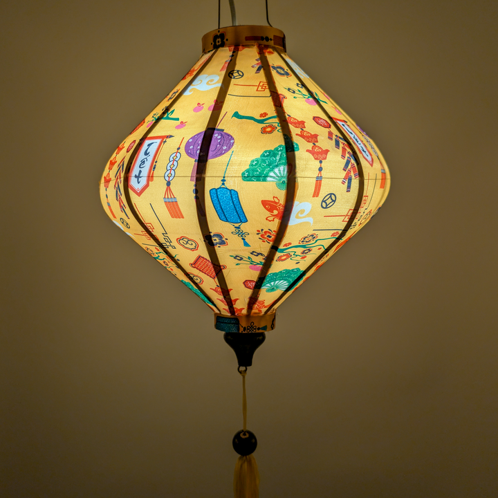 Glowing Lozenge shaped yellow lantern with matching yellow tassel in Lunar New Year theme.