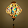 Glowing Lozenge shaped yellow lantern with matching yellow tassel in Lunar New Year theme.