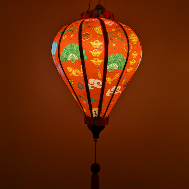 Glowing balloon shaped lantern with lunar new year patterns on a red background