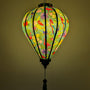 Glowing lantern with colourful birds and floral pattern on a blue teal background