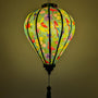 Glowing lantern with colourful birds and floral pattern on a blue teal background