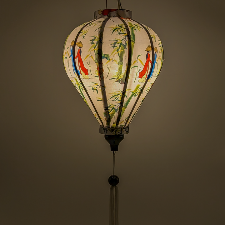 Glowing balloon shape handcrafted from luxurious polyester silk, with a charming countryside scene featuring women in áo dài, bamboo groves, and little boys playing an instrument while sitting on water buffalos. 